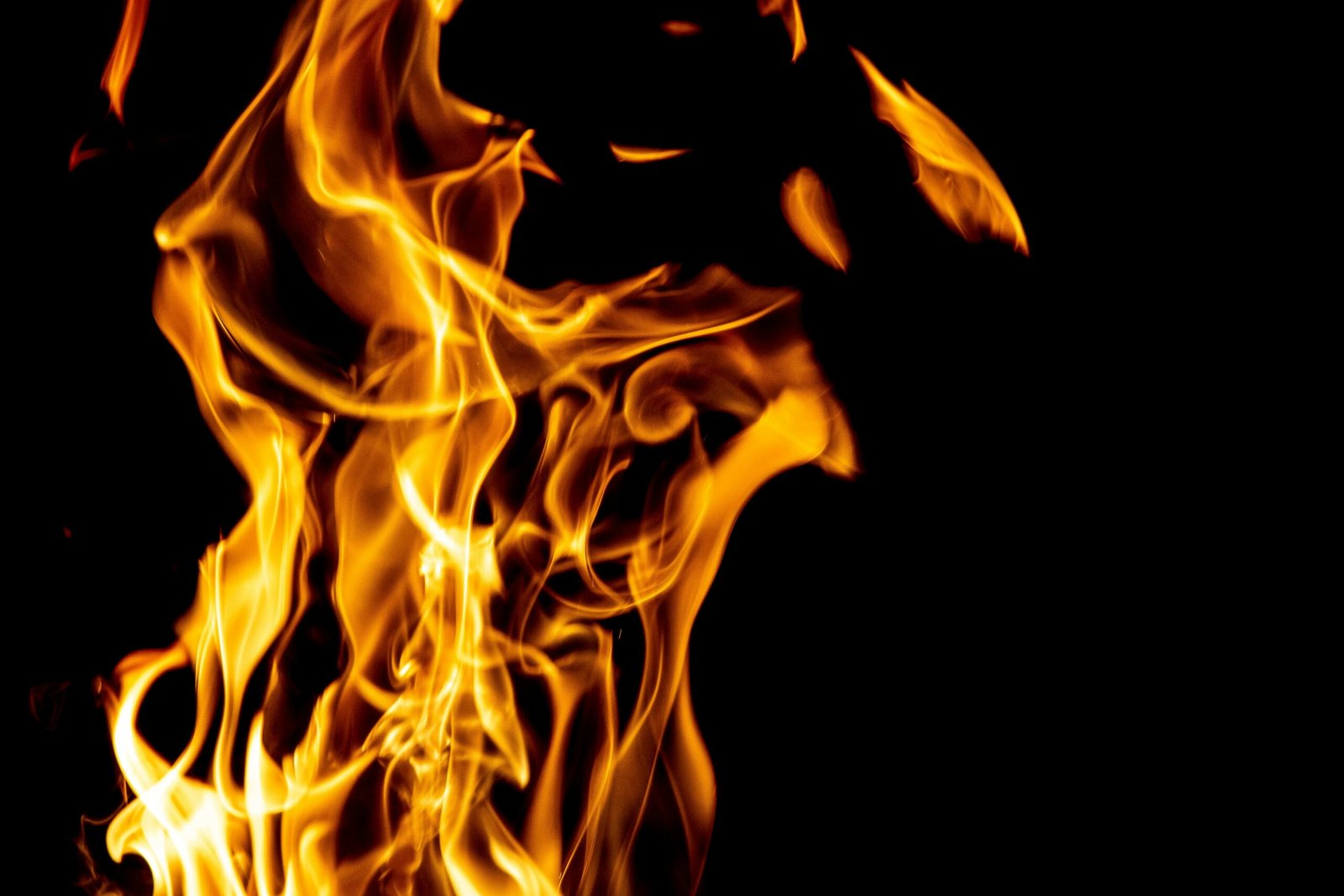 Captivating image of fiery flames rising against a black backdrop, showcasing the beauty of fire.